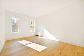 Brooklyn apartment for rent - A room with wooden floors and two windows.