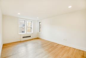 Brooklyn apartment for rent - A room with wooden floors and white walls.