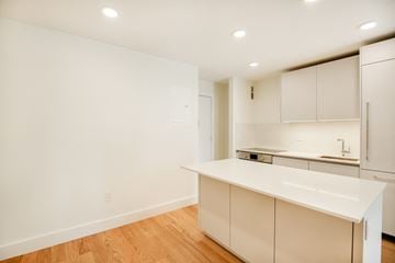 Brooklyn apartment for rent - A kitchen with white cabinets and a white countertop.