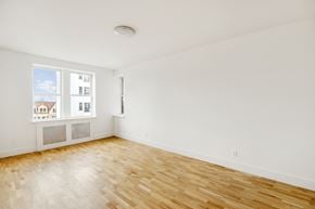 Brooklyn apartment for rent - the living room of an apartment with wood floors and a window
