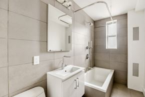 Brooklyn apartment for rent - a bathroom with a sink toilet and a mirror