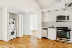 Brooklyn apartment for rent - an empty kitchen with a washing machine and a washer and dryer in it