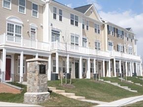 Gaithersburg townhouse for rent - a large white building with stairs and a stone tower