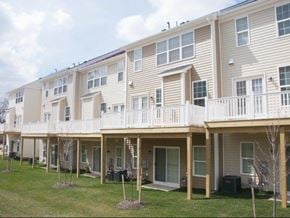 Gaithersburg townhouse for rent - a row of houses with a porch and a yard