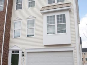 Gaithersburg townhouse for rent - a white house with white siding and a garage