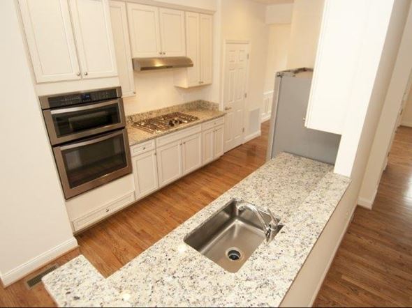 Gaithersburg townhouse for rent - a kitchen with white cabinets and a sink