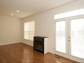 Gaithersburg townhouse for rent - an empty living room with a fireplace and a door