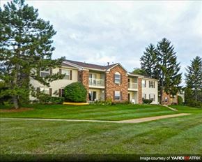 Northville apartment for rent - A large house with a green lawn in front.