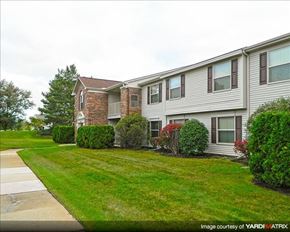 Northville apartment for rent - A residential building with a well-maintained lawn and shrubbery.