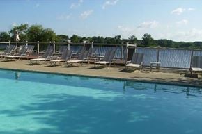 Northville apartment for rent - a pool with a bunch of chairs sitting next to it
