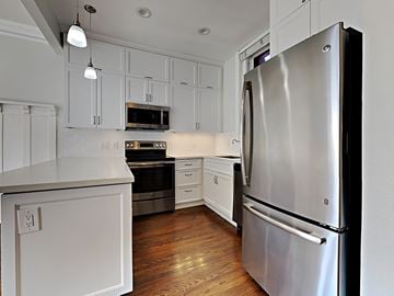 San Francisco apartment for rent - a kitchen with stainless steel appliances and white cabinets
