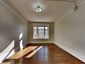 San Francisco apartment for rent - an empty living room with wood floors and a window