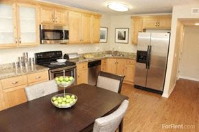 Sacramento apartment for rent - Sacramento CA Apartment - La Provence -  Wooden Dining Room Table, Fruit Center Piece, and Wood Floors
