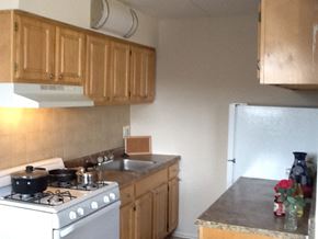 Philadelphia apartment for rent - Kitchen with granite countertops, beige tile backsplash, and white appliances