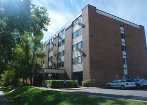 Nashwauk apartment for rent - a large brick building with cars parked in front of it