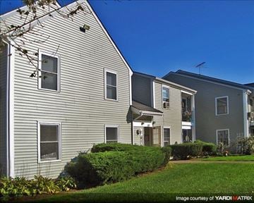 Duxbury apartment for rent - a gray house with a yard in front of it