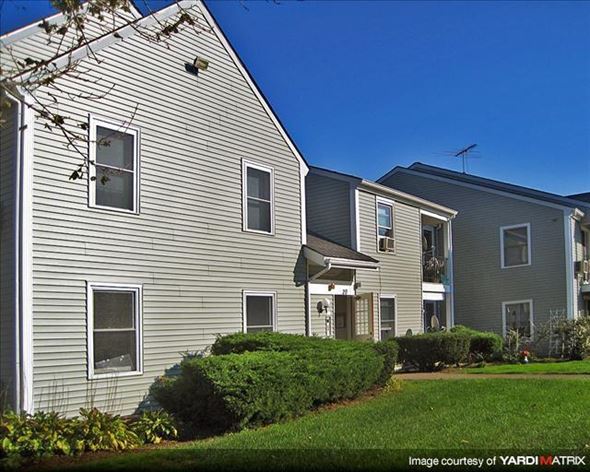 Duxbury apartment for rent - a gray house with a yard in front of it