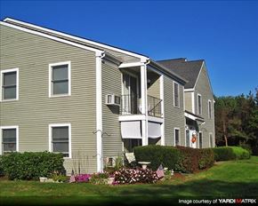 Duxbury apartment for rent - a gray house with a balcony and a yard