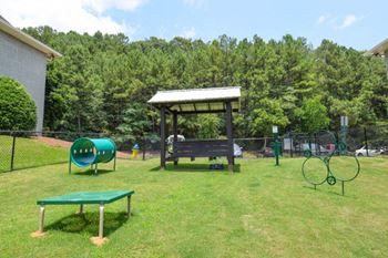 Pet park with covered seating and agility equipment