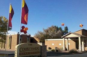 Albuquerque apartment for rent - The Courtyards Apartments sign is in front of a building.