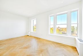 Brooklyn apartment for rent - a living room with a wood floor and three windows