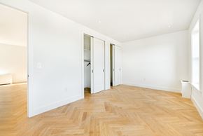 Brooklyn apartment for rent - an empty living room with white walls and wood floors