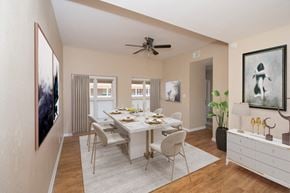 Austin apartment for rent - a dining room with a table and chairs and a ceiling fan