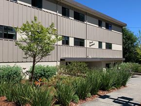 Burlingame apartment for rent - an office building with a sidewalk and plants in front of it