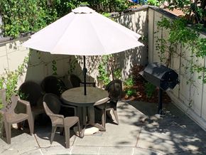 Burlingame apartment for rent - a patio with a table and chairs under an umbrella