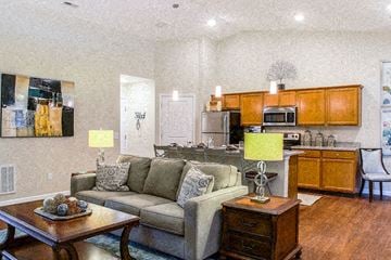 Greer apartment for rent - A living room with a couch, a coffee table, and a painting on the wall.