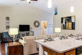 Greer apartment for rent - A living room with a couch, chair, and a table.