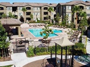 Modesto apartment for rent - Pool with lounge chairs l The Villas at Villaggio Apartments in Modesto CA 