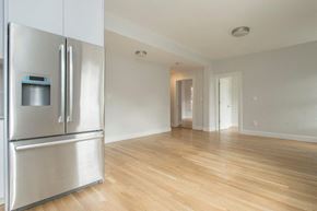 Boston apartment for rent - an empty living room with a stainless steel refrigerator