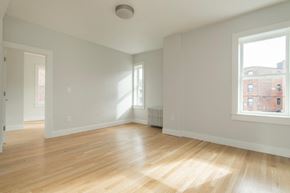 Boston apartment for rent - an empty living room with a hard wood floor