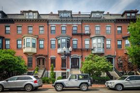 Boston apartment for rent - a brick apartment building with cars parked in front of it