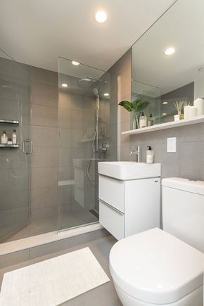 Boston apartment for rent - a white bathroom with a shower toilet and sink