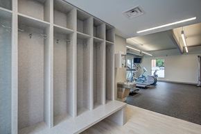 Kalamazoo apartment for rent - a large room with a gym with machines and a wood floor