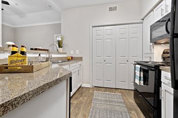 Luxury package includes: white cabinetry in kitchen & bathrooms, black appliance package, granite-style countertops, updated flooring, lighting & hardware,  two-tone designer paint & framed bathroom mirrors