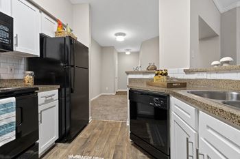Luxury package includes: white cabinetry in kitchen & bathrooms, black appliance package, granite-style countertops, updated flooring, lighting & hardware,  two-tone designer paint & framed bathroom mirrors