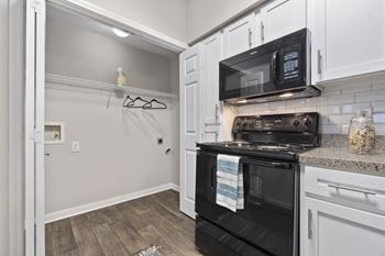 Luxury package includes: white cabinetry in kitchen & bathrooms, black appliance package, granite-style countertops, updated flooring, lighting & hardware,  two-tone designer paint & framed bathroom mirrors