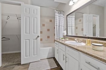 Luxury package includes: white cabinetry in kitchen & bathrooms, black appliance package, granite-style countertops, updated flooring, lighting & hardware,  two-tone designer paint & framed bathroom mirrors