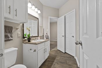Luxury package includes: white cabinetry in kitchen & bathrooms, black appliance package, granite-style countertops, updated flooring, lighting & hardware,  two-tone designer paint & framed bathroom mirrors