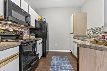 Premiere package includes: black appliance package, granite-style countertops, updated flooring, lighting & hardware,  two-tone designer paint & framed bathroom mirrors