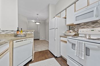 Standard package includes: white appliance package, granite-style countertops & two-tone designer paint