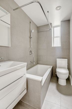 Brooklyn apartment for rent - a bathroom with a toilet and a tub and a sink