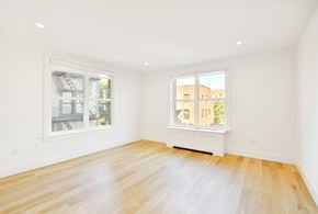 Brooklyn apartment for rent - a living room with a hardwood floor and two windows