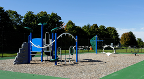 Grandville apartment for rent - A playground with a blue and green play structure and a green surface.