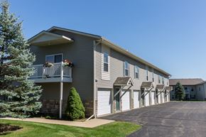 Caledonia apartment for rent - a gray house with white doors and a driveway
