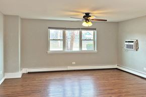 Oak Park apartment for rent - A room with a ceiling fan and a window.