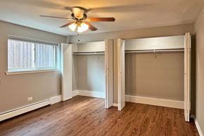 Oak Park apartment for rent - A room with a ceiling fan and sliding glass doors.